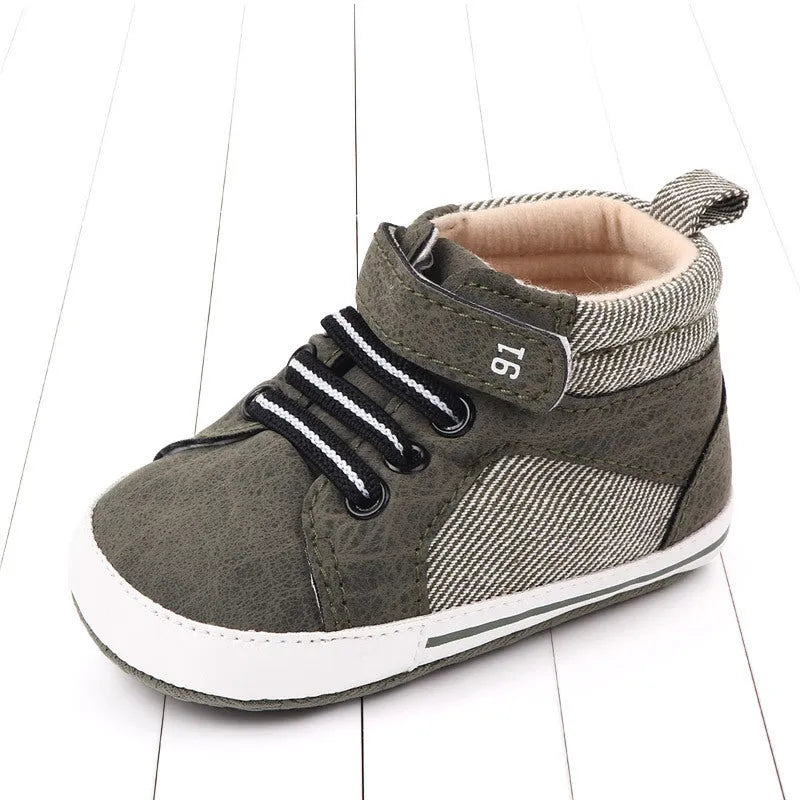 Blue cotton high-top toddler shoes with velcro strap for boys on white background