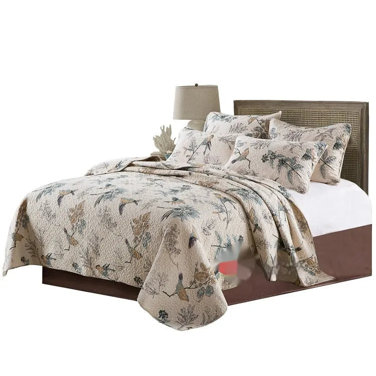Quilted pure cotton bed cover with printed design, shown on a double bed with two matching pillowcases.