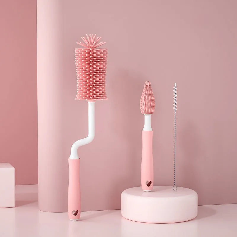 Three silicone baby bottle brushes in pink, blue, and yellow colours including a straw cleaning brush.