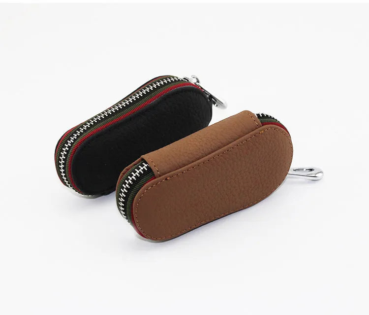 Brown leather car universal key case holding a car key on a white background