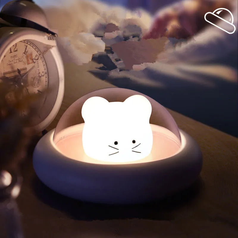 Space Moe Mouse children's bedroom night light in blue with push switch and warm LED glow on a bedside table