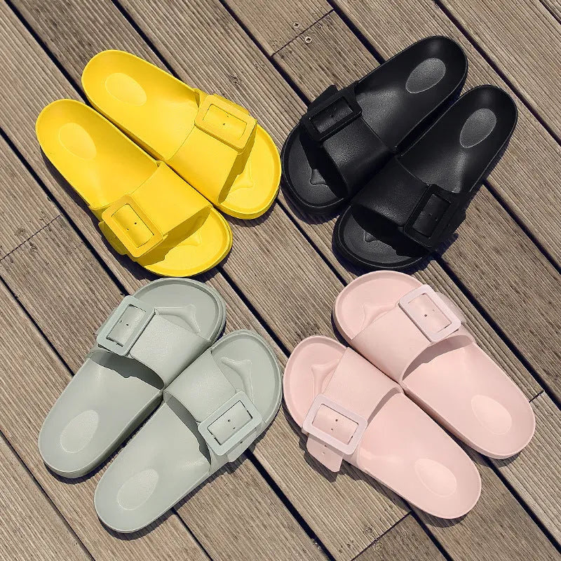 Women's grey blue flip-flop slippers with a silver adjustable buckle on the strap.