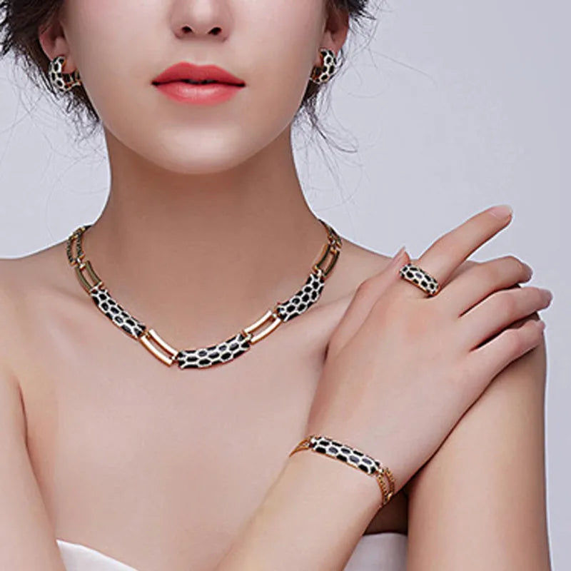 Costume jewellery set for women with 18K electroplated alloy, drop oil detail, and water drill accents in black, purple, or white.