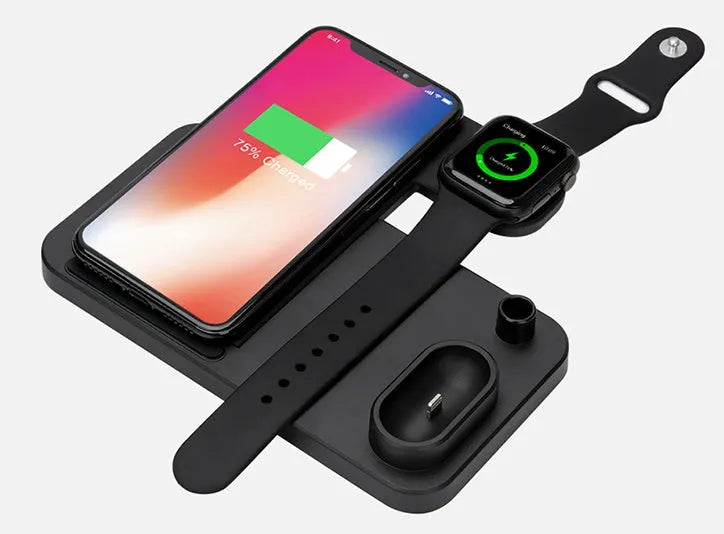 A white 4-in-1 wireless charging station with an iPhone, Apple Watch, and AirPods charging on its adjustable, foldable stand.
