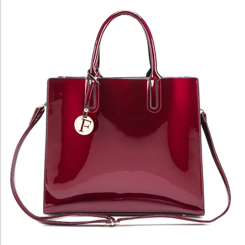 Three soft patent leather handbags in solid colours for women, shoulder and crossbody style with zipper closure