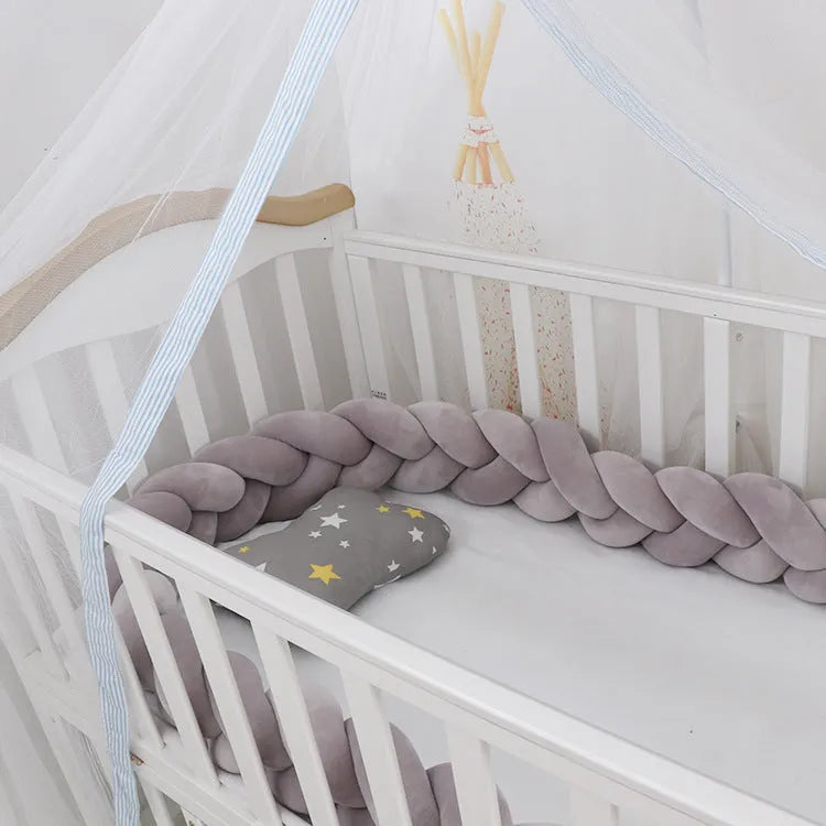 Long, flexible baby crib bumper pillow in spandex velvet, shown fitted around a white cot for safety protection.