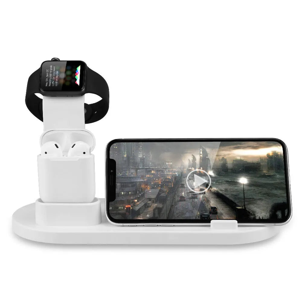 White three-port USB headphone charging stand holding wireless headphones and earbuds