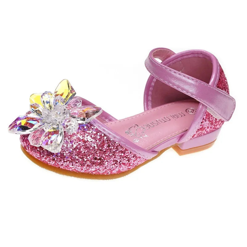 Girls crystal shoes with rhinestone decoration on shiny fabric upper, available in pink, blue, and silver