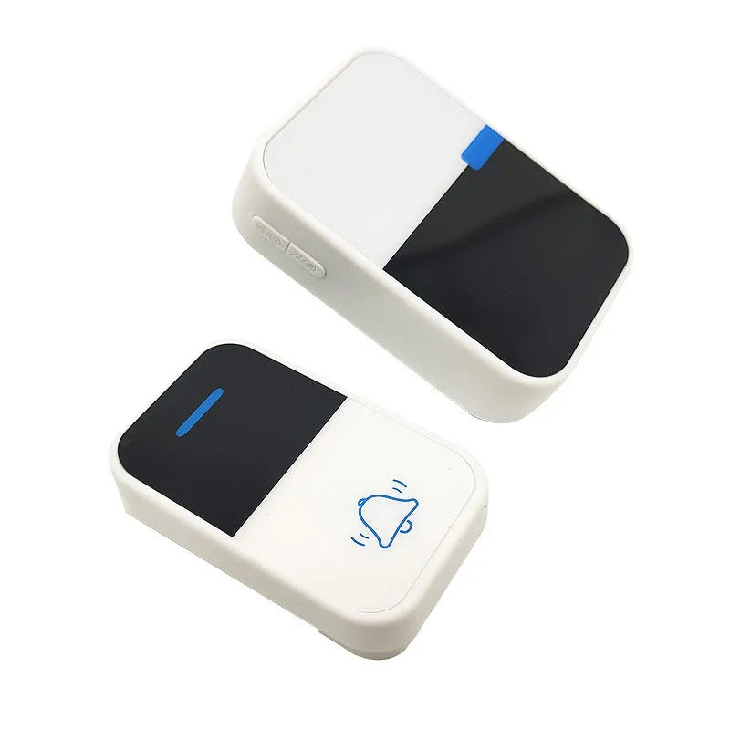 White wireless doorbell receiver and transmitter with modern design on a wooden table.
