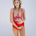 Red high waist maternity swimsuit with matching swim trunks on a pregnant woman