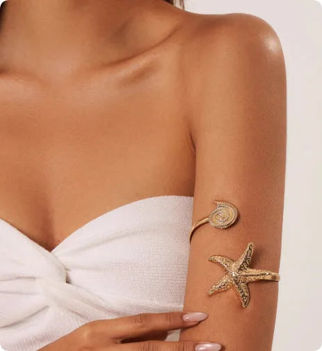 Gold plated alloy anklet with small starfish design on white background