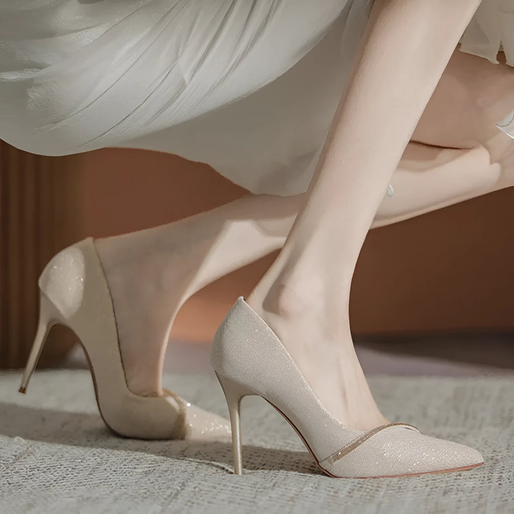 Women's gold stiletto court shoes with pointed toe and 9cm heel on white background