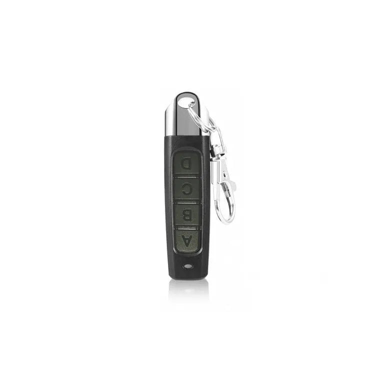 A compact black rolling door remote control showing buttons for copying and testing signals.
