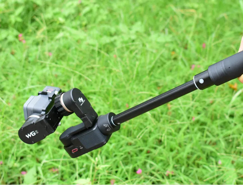Black retractable aluminium selfie stick extended to its full 1-metre length with a universal phone mount attached.
