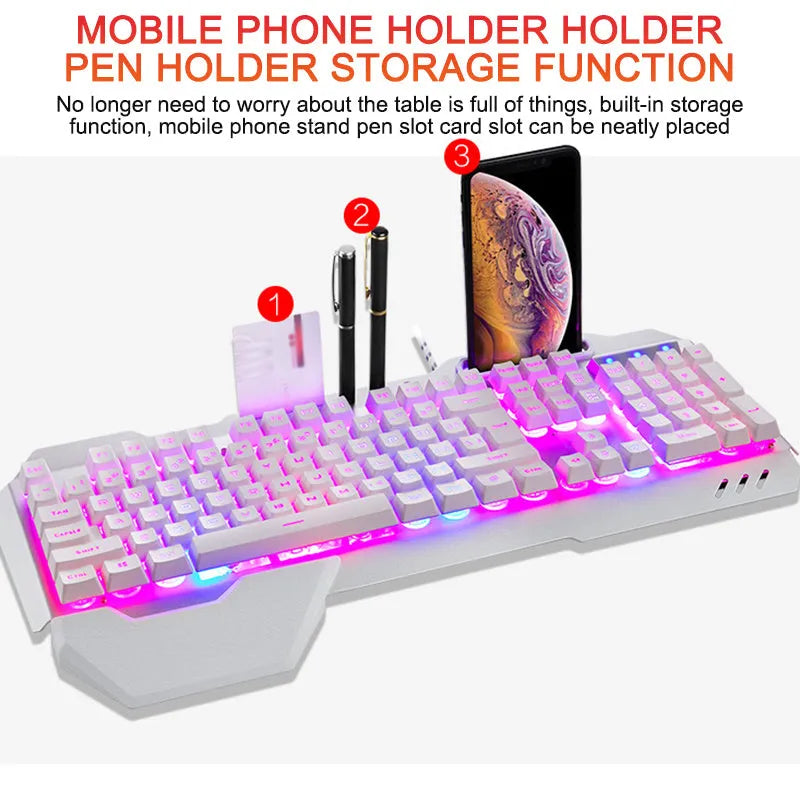 Black wired gaming keyboard with RGB backlight, phone holder, pen tray, and magnetic wrist rest on a desk