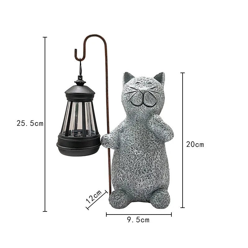 Solar-powered garden light with decorative resin kitten ornament lifting a lamp.