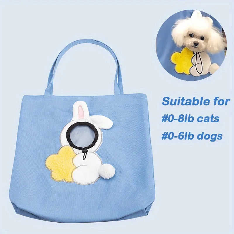 Blue canvas pet carrier shoulder bag with an open side showing a cat's head, featuring safety zippers and an animal print design.