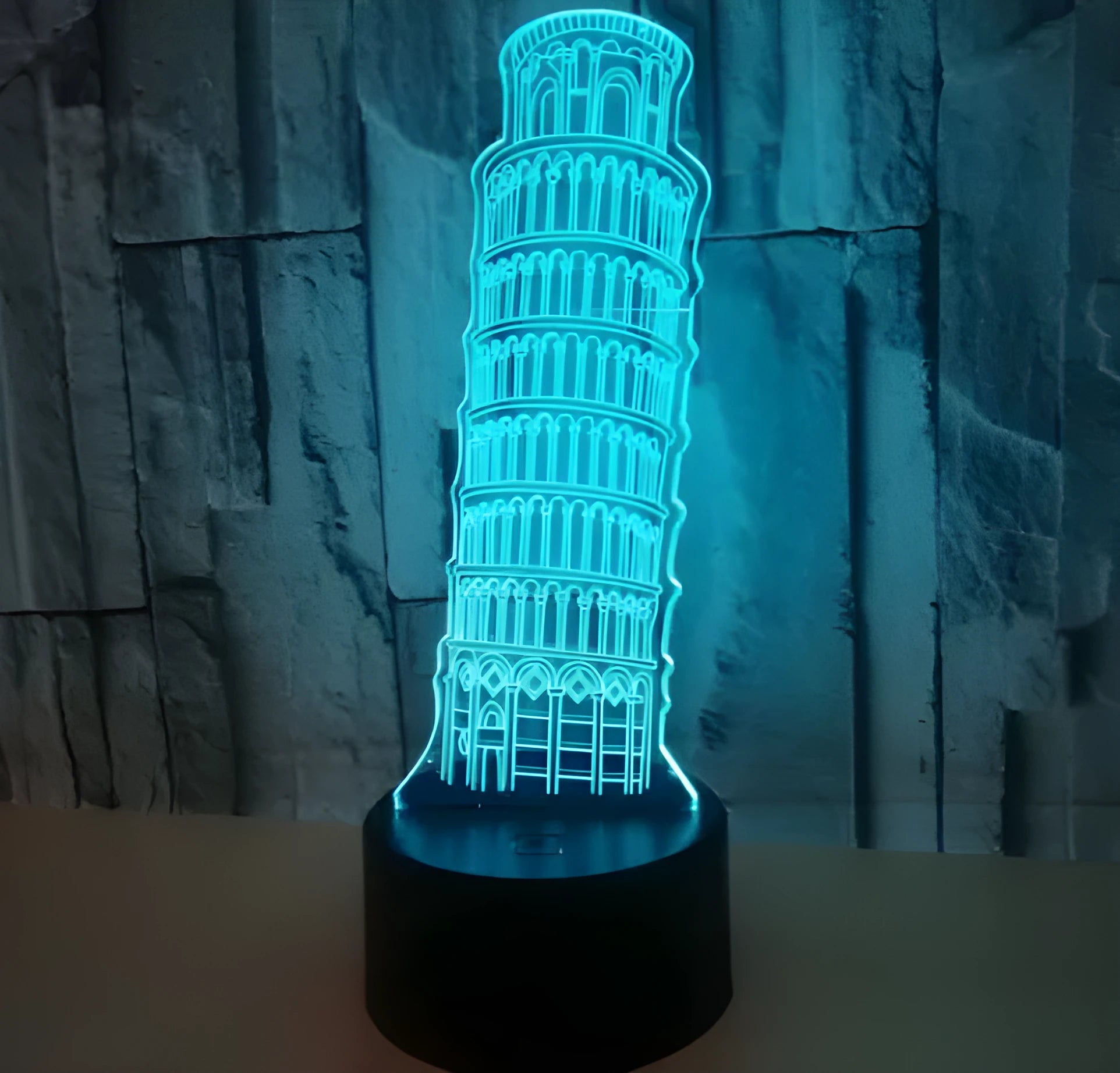 3D laser-cut Leaning Tower of Pisa acrylic night light glowing in blue on a black base.