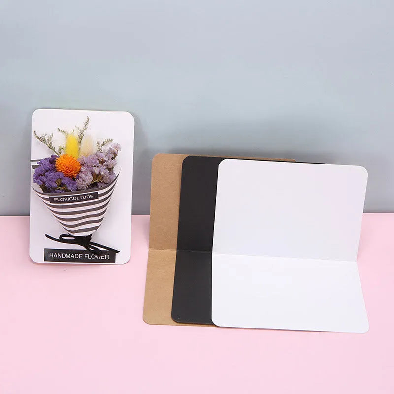 Pack of 100 blank folded kraft cards in 10x15cm size on a craft table