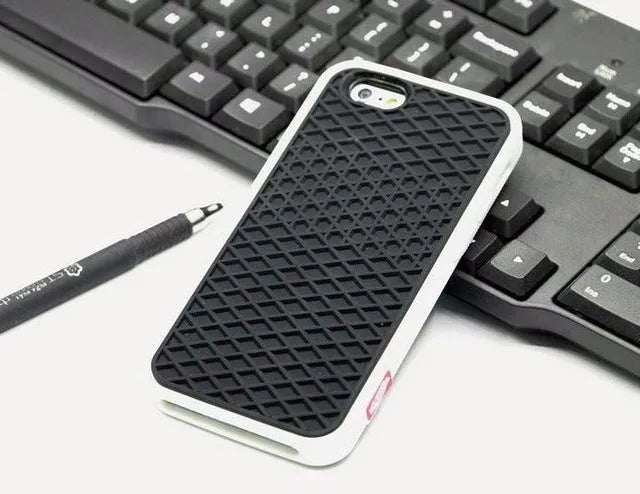Waffle sole silicone phone case for iPhone 6s with checker pattern texture in black edge on brown background