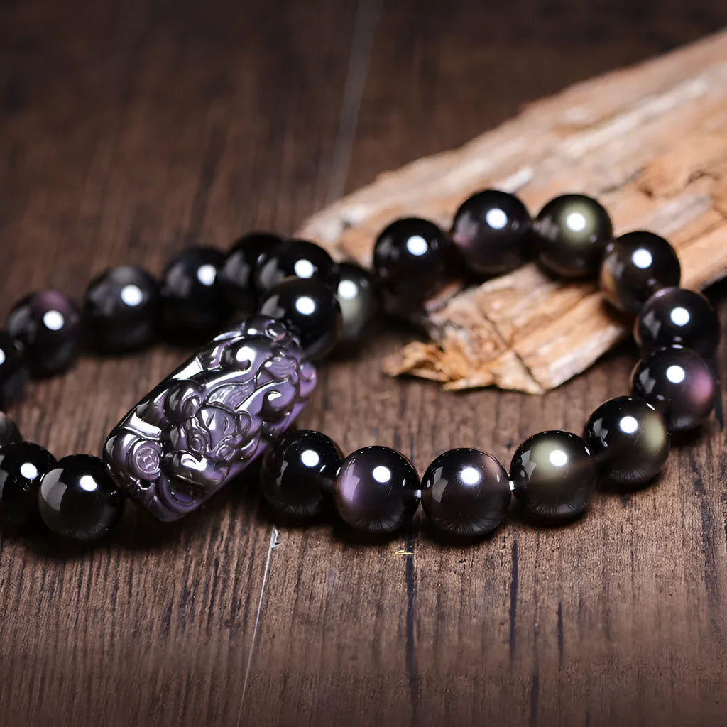 Polished crystal Pi Xiu bracelet with geometric ethnic design on a wrist, showing double eye ice stone pattern.