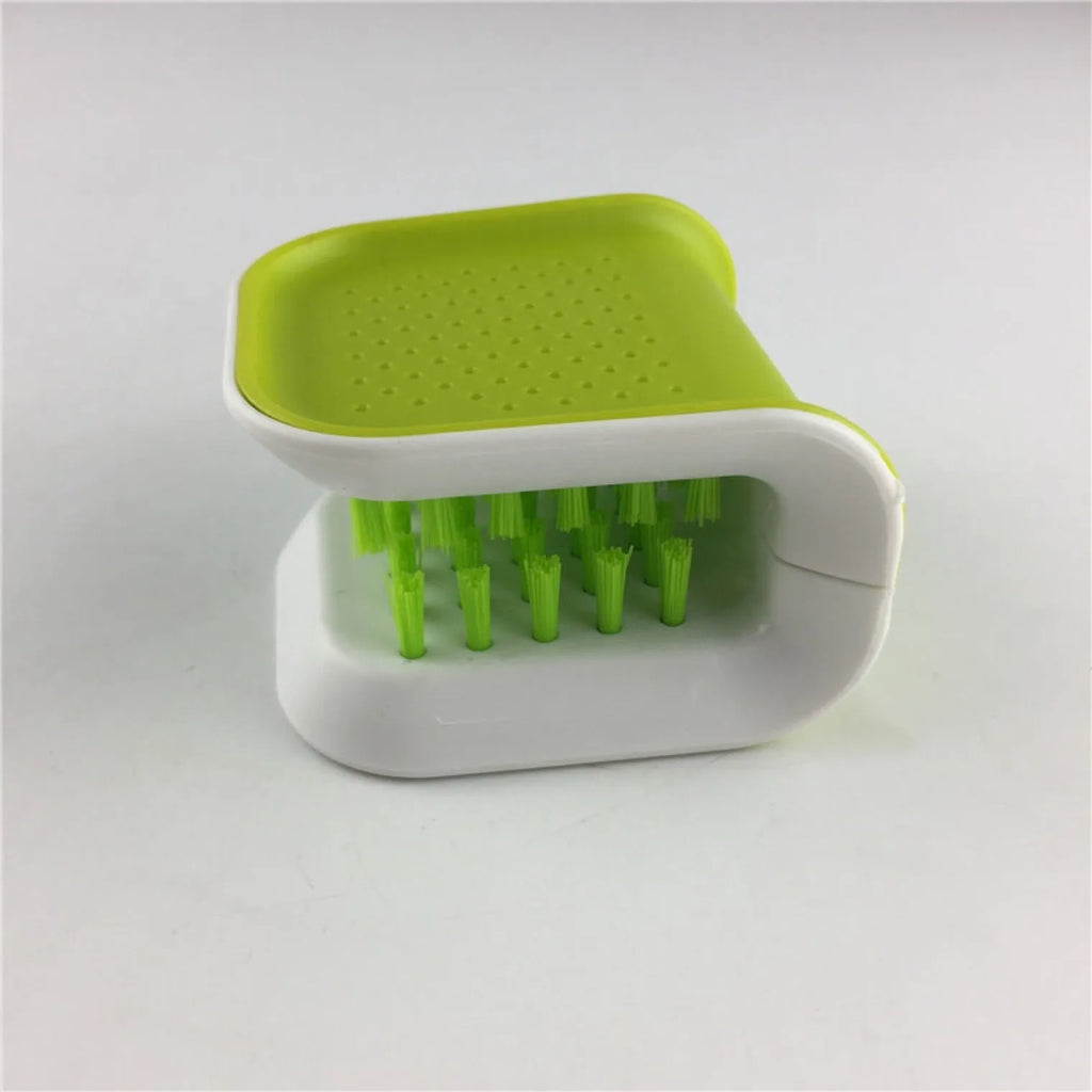 Blue U-shaped plastic brush for cleaning knives and forks in kitchen sink