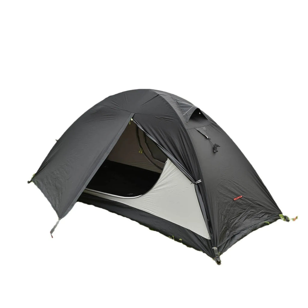 Single person hiking tent in orange pitched in a forest, showing aluminium poles and double-layer design with mesh panel.