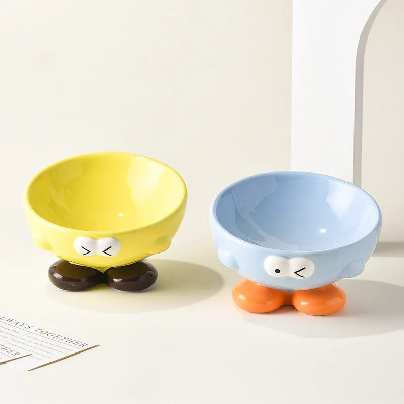 Oblique ceramic pet bowl with cute expression pattern, tall design for cervical spine protection