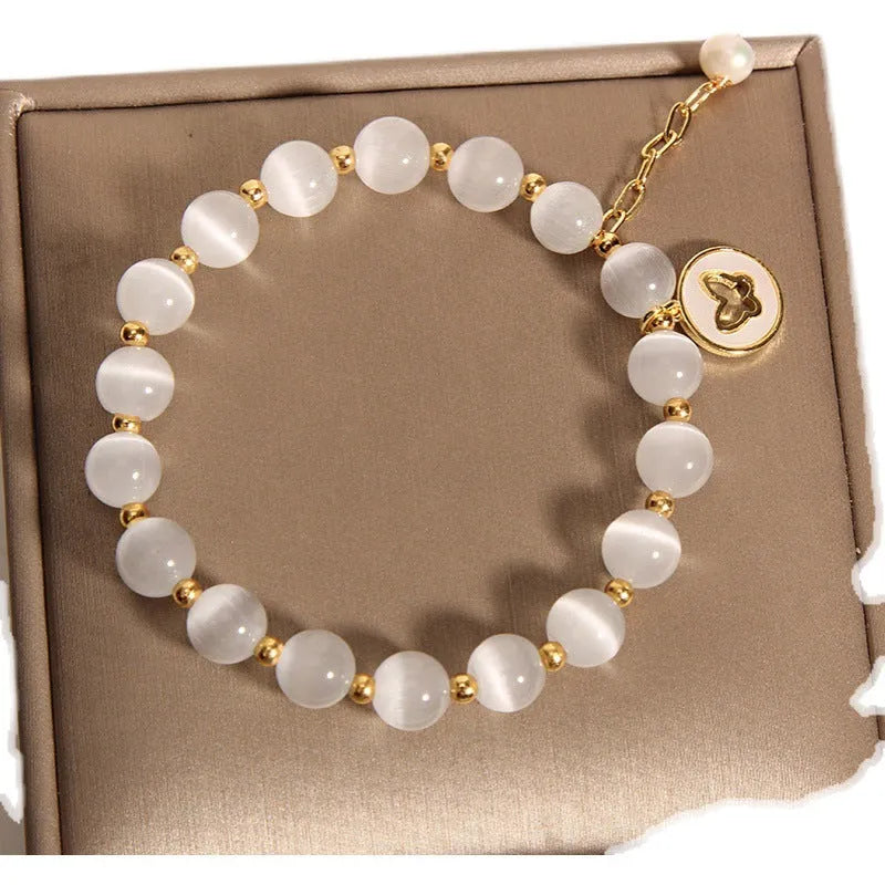 Handmade white cat's eye crystal bracelet with geometric Korean-style design.