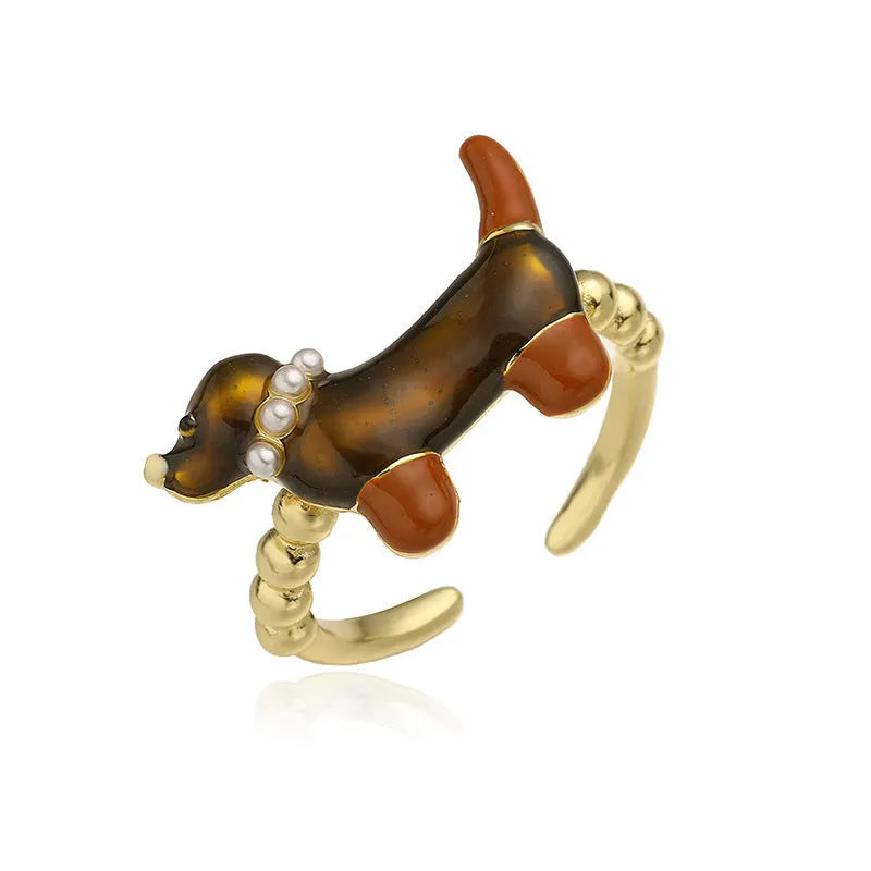 Copper open mouth ring with colourful drip oil finish and sausage dog animal motif