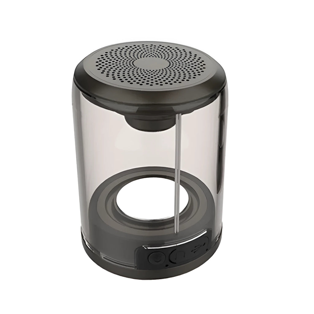 Transparent Bluetooth speaker with black housing and suction cup base on a glass table