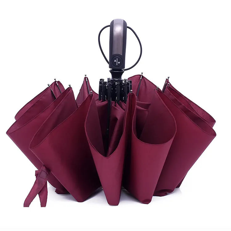 Automatic triple folding business umbrella in black, showing steel ribs and rubber handle.