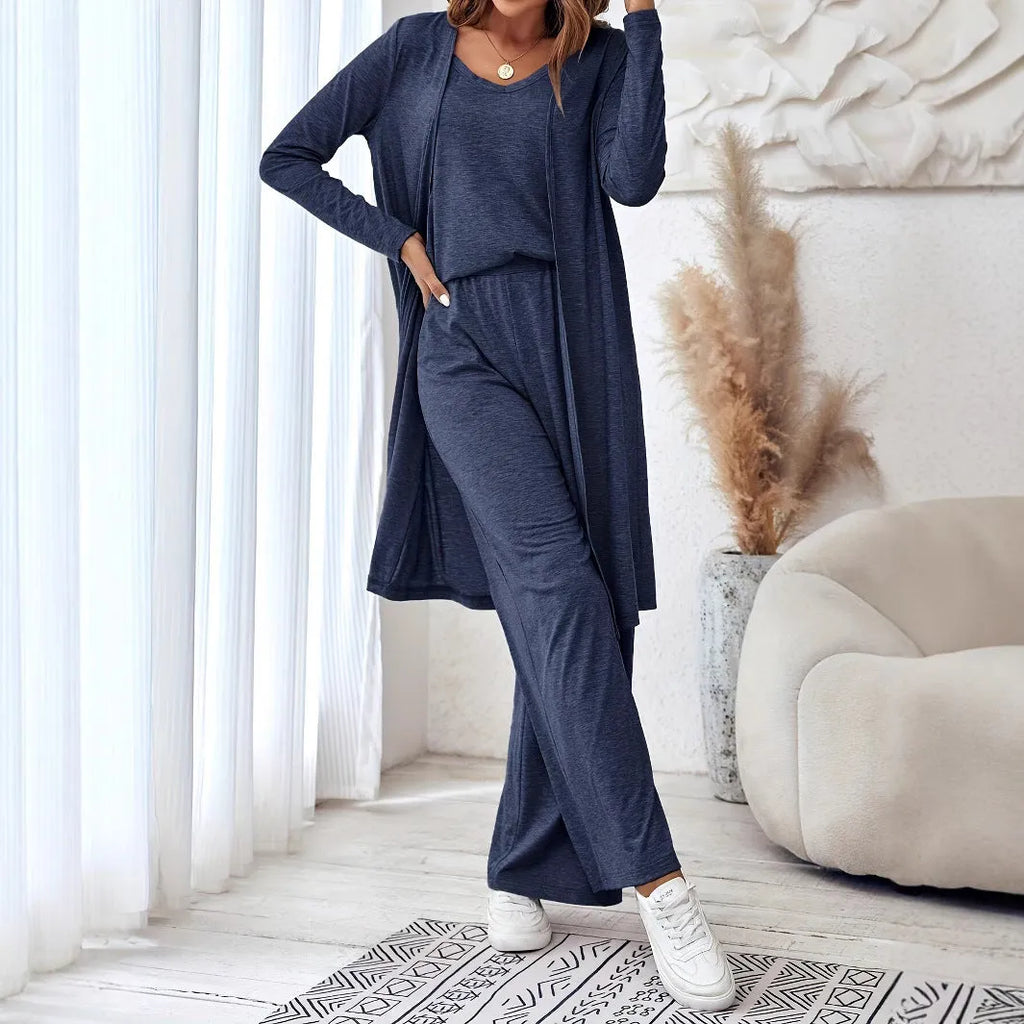 Blue women's three-piece suit with sling top, long cardigan, trousers, and suspenders on a mannequin.