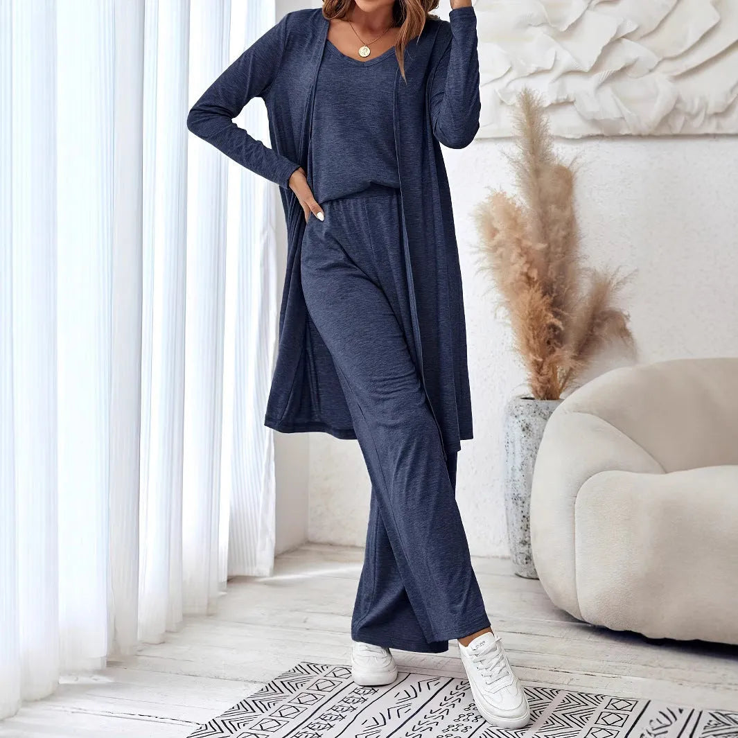 Blue women's three-piece suit with sling top, long cardigan, trousers, and suspenders on a mannequin.