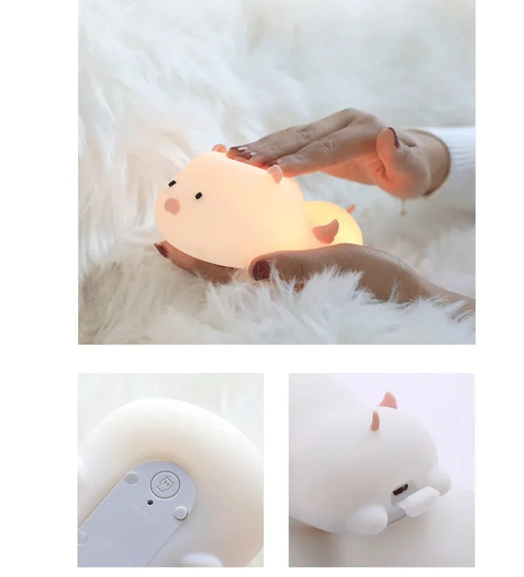Blue rechargeable silicone night light shaped like a sleeping pig with soft LED glow.