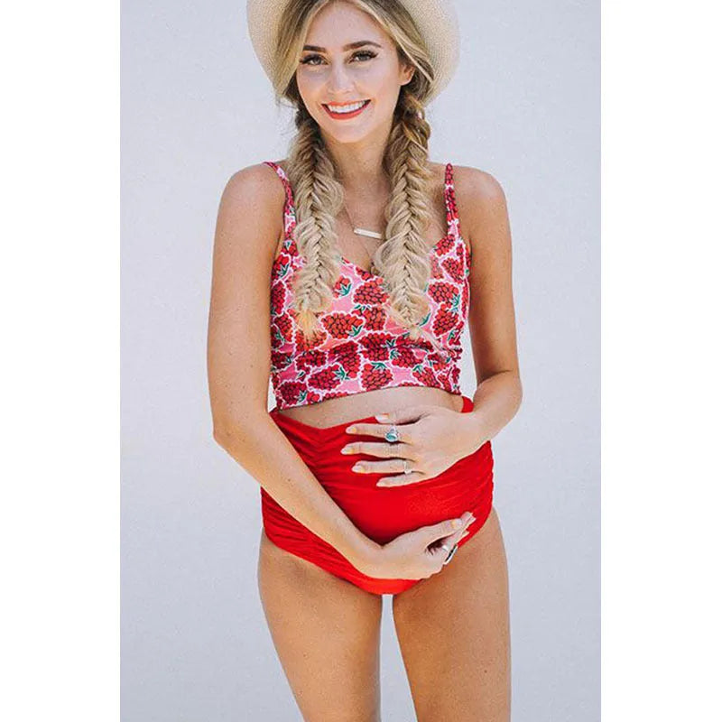 Red high waist maternity swimsuit with matching swim trunks on a pregnant woman