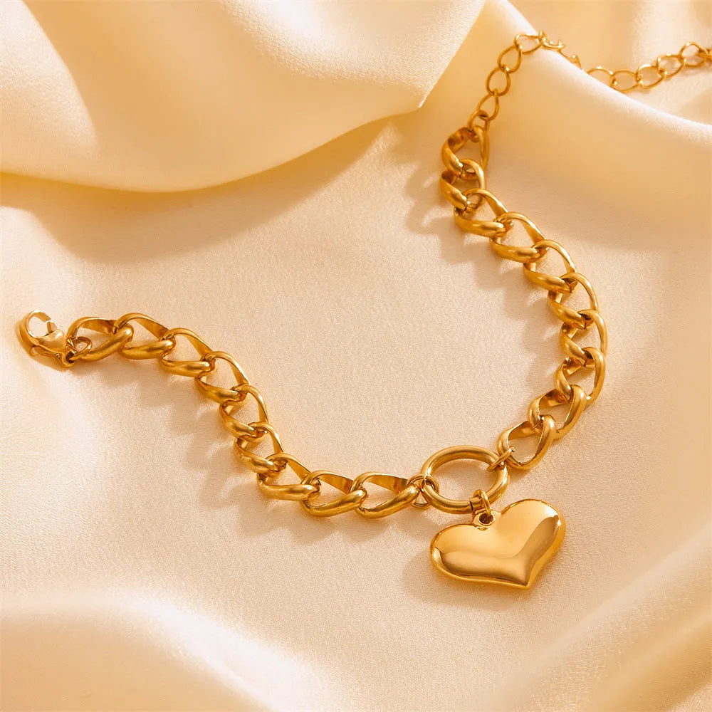 Titanium steel round chain bracelet with heart charm and petal detailing in gold N510