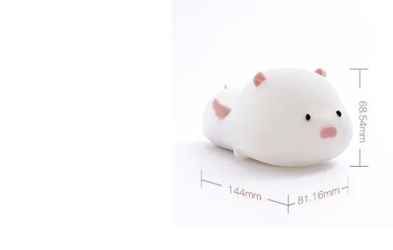 Blue rechargeable silicone night light shaped like a sleeping pig with soft LED glow.