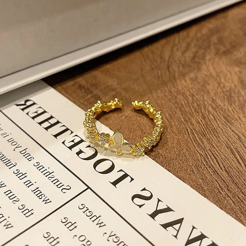 Simple copper women's ring with a Chinese butterfly design, showing an example from the 33 available numbered styles.