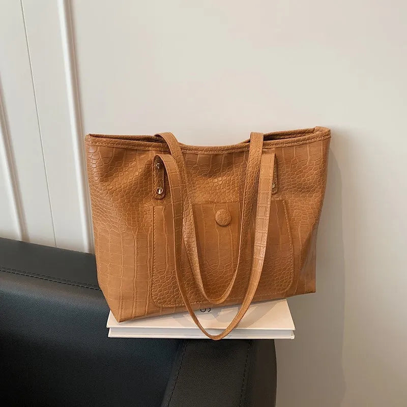 Retro large capacity single-shoulder handbag in brown, soft PU material with stitching detail, horizontal square shape.