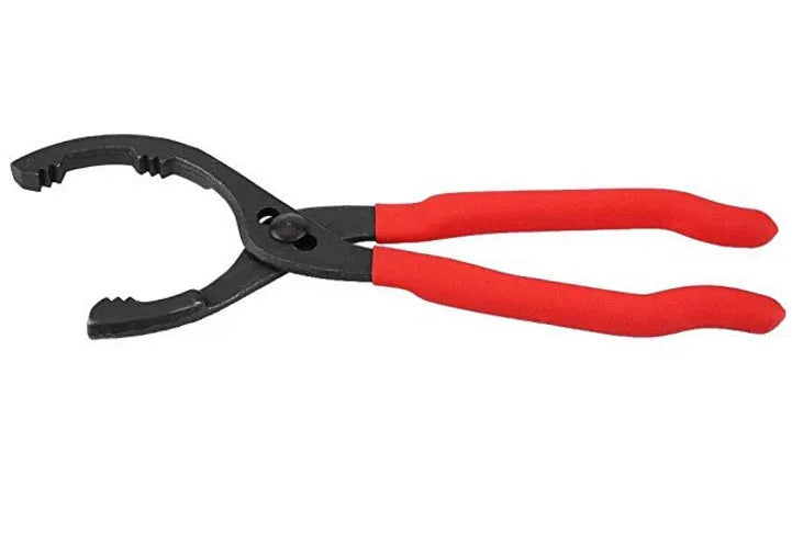 Red 12 inch high carbon steel filter wrench for removing oil filters, laid on a workshop surface