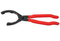 Red 12 inch high carbon steel filter wrench for removing oil filters, laid on a workshop surface