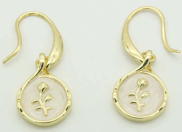 Drop-shaped brass earrings with rose inlay and zircon stones in a teardrop silhouette