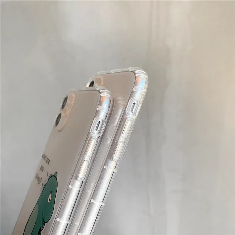 Clear transparent iPhone case with green dinosaur design on back, showing airbag-style edges.