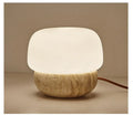 Cream-coloured retro glass bedside lamp with a button switch on its base.