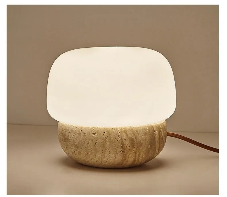 Cream-coloured retro glass bedside lamp with a button switch on its base.