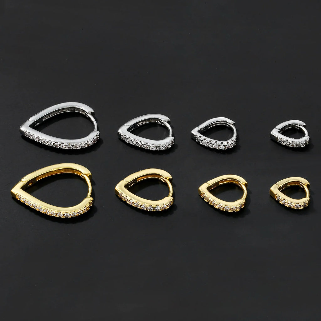 A geometric heart-shaped gold ear clip for women on a white background.