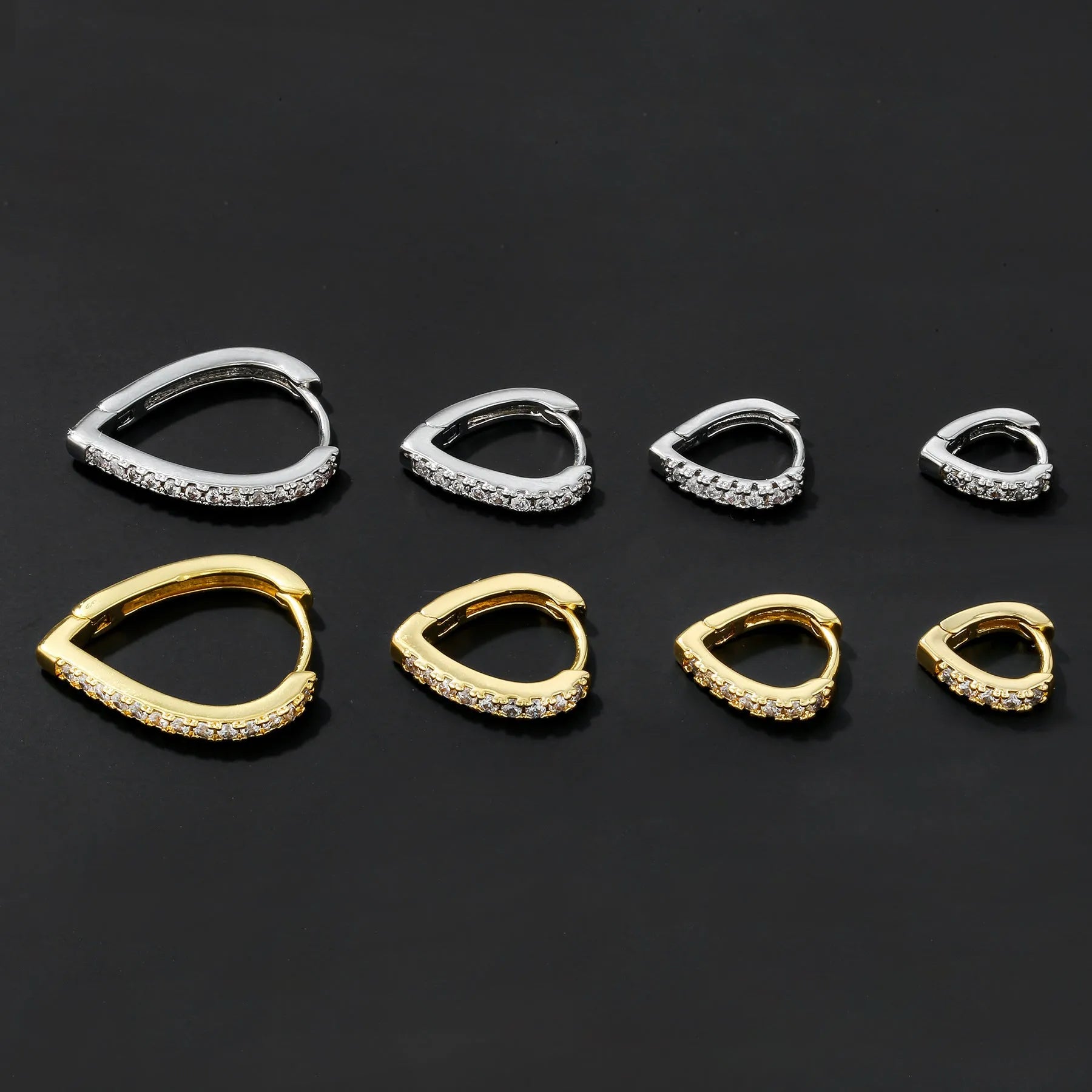 A geometric heart-shaped gold ear clip for women on a white background.