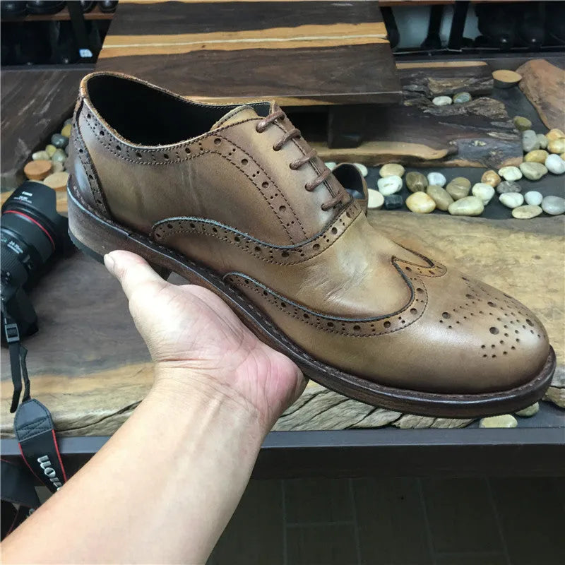 Light brown men's vintage distressed leather lace-up shoes with carved detailing on the upper.