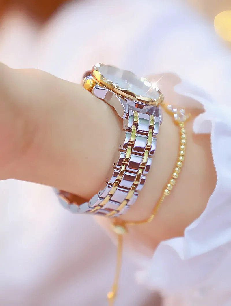 Women's quartz watch with 32mm round dial, alloy case, and mineral glass in a choice of gold or silver finishes